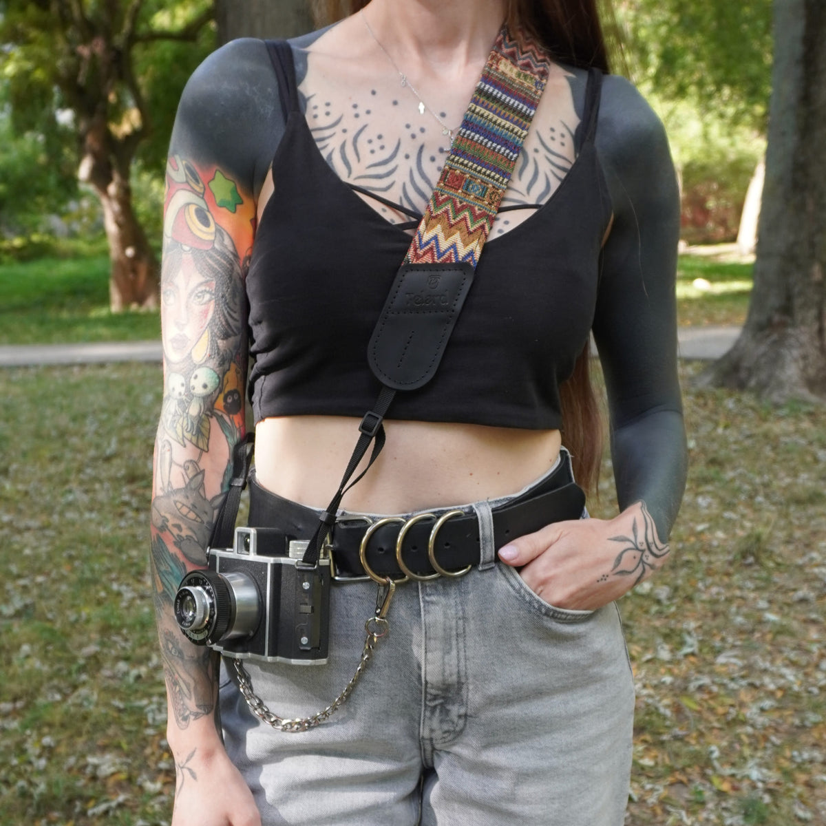 Black leather and boho pattern fabric camera strap on woman lifestyle