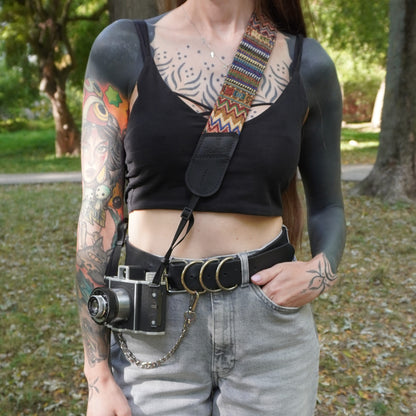 Black leather and boho pattern fabric camera strap on woman lifestyle