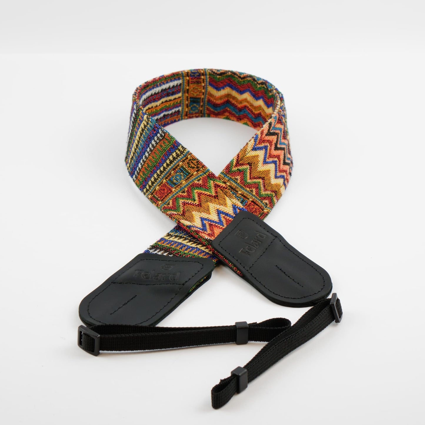 A camera strap featuring a vibrant, multicolored geometric woven pattern with black leather ends and a black adjustable webbing strap, displayed on a clean white background.