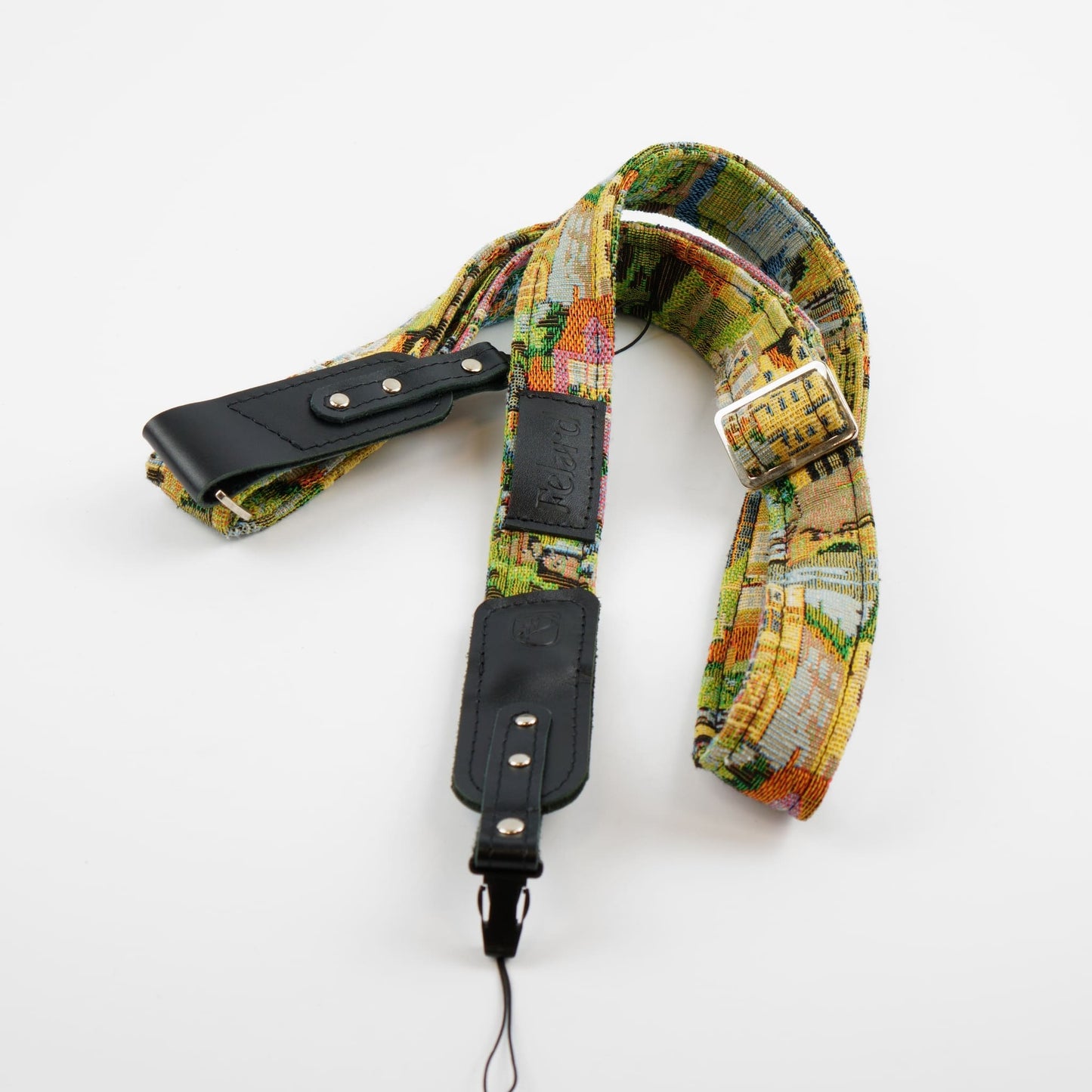 A vintage-style camera strap featuring a colorful, multicolor pattern with accented by black leather sections and silver metal hardware, displayed on a clean white background.