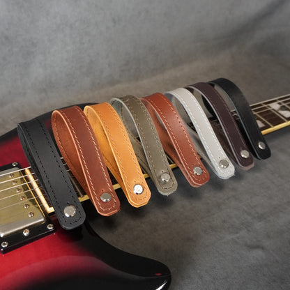 Handmade guitar headstock adapters with vintage matte and smooth glossy leather finishes