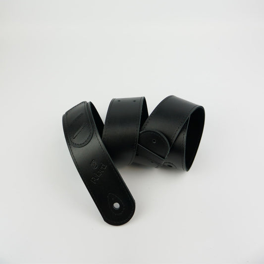 A black leather guitar strap on a white background.