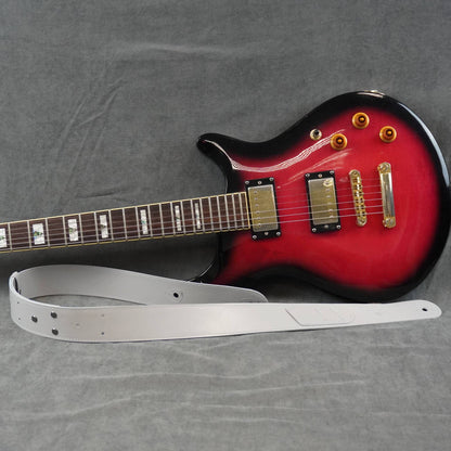 Handmade leather guitar strap with picks holder near electric guitar