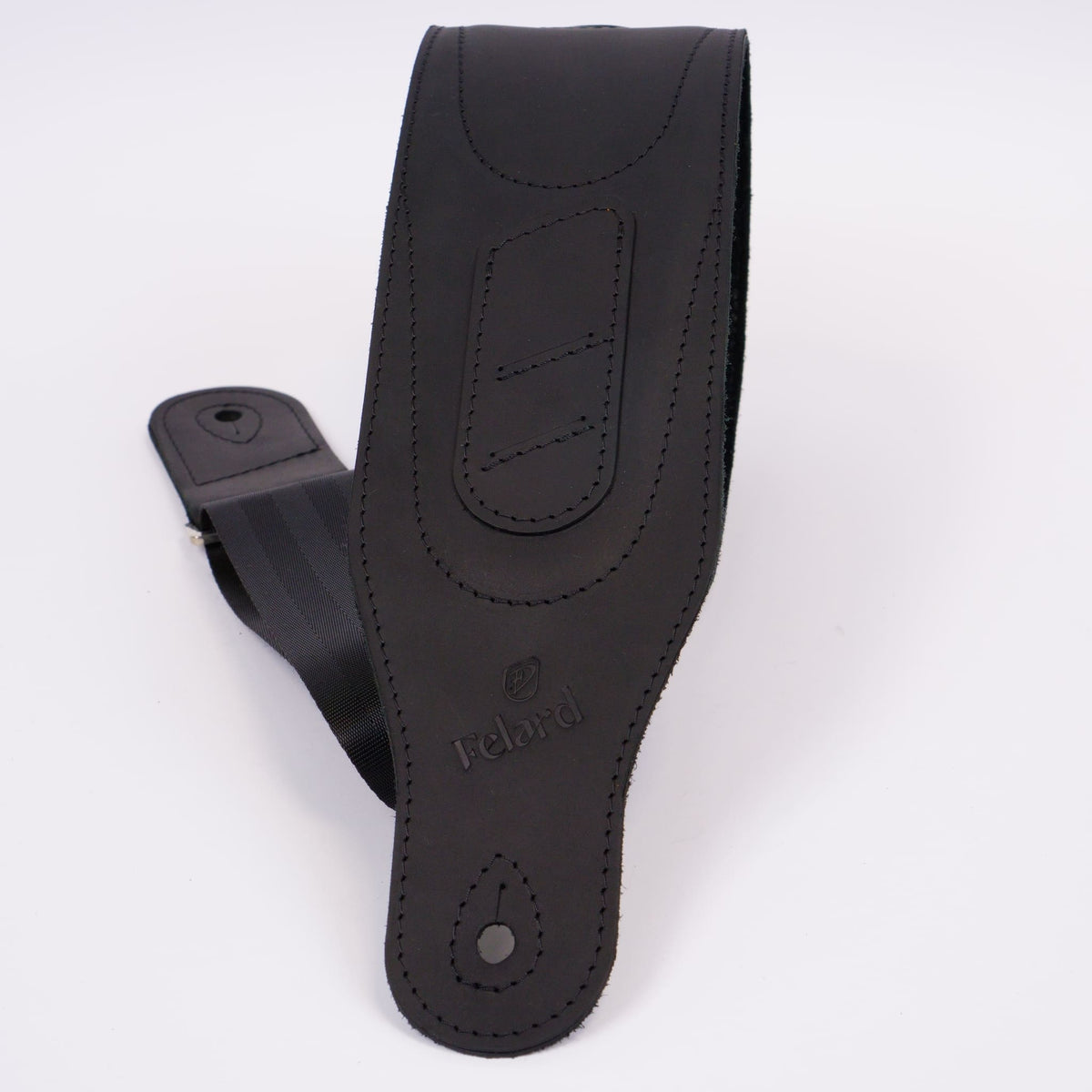 A black leather guitar strap with visible stitching and the embossed brand name 'Felard' on a clean white background.