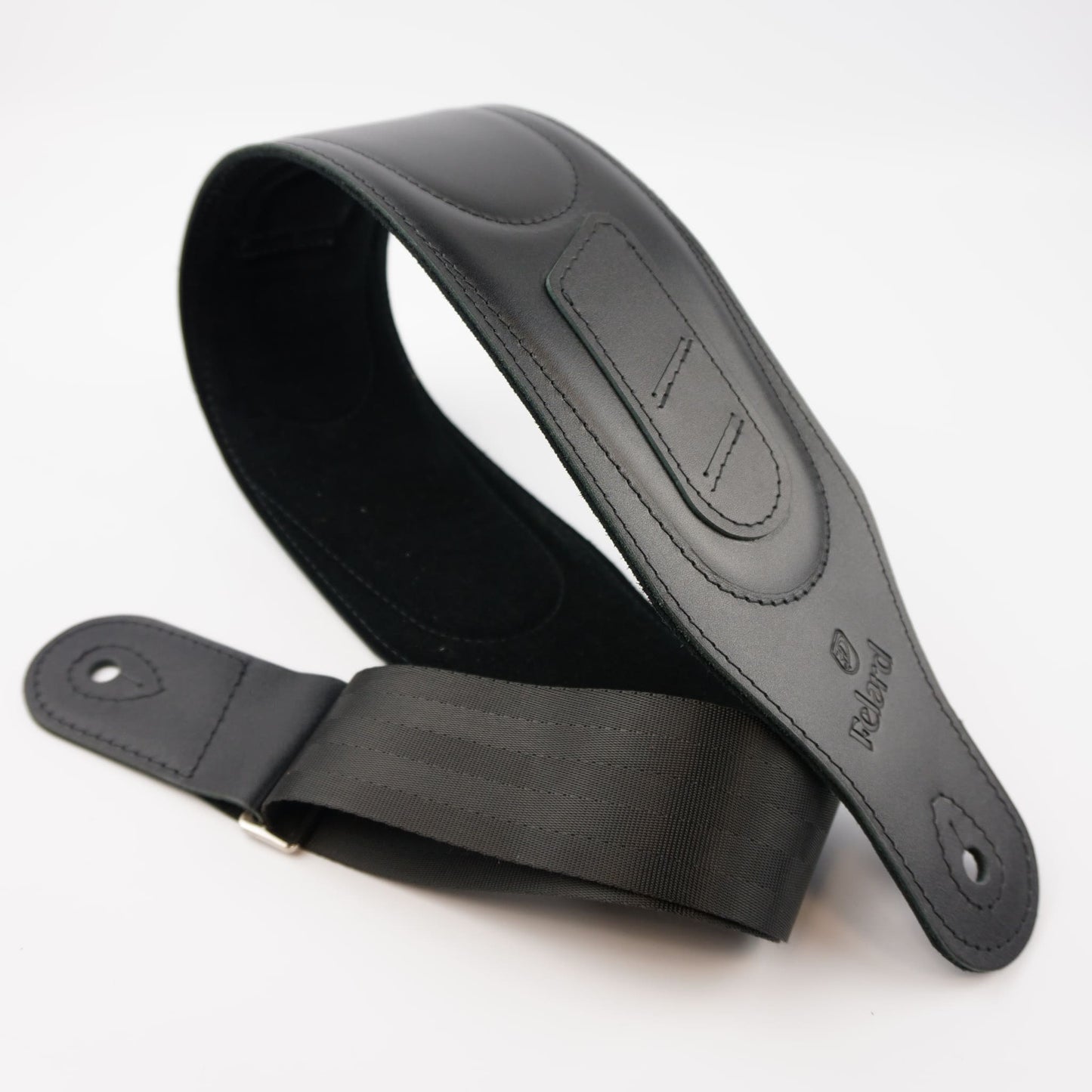 A black guitar strap made of leather and webbing, shown on a clean white background. The brand name 'Felard' is embossed on the leather end.