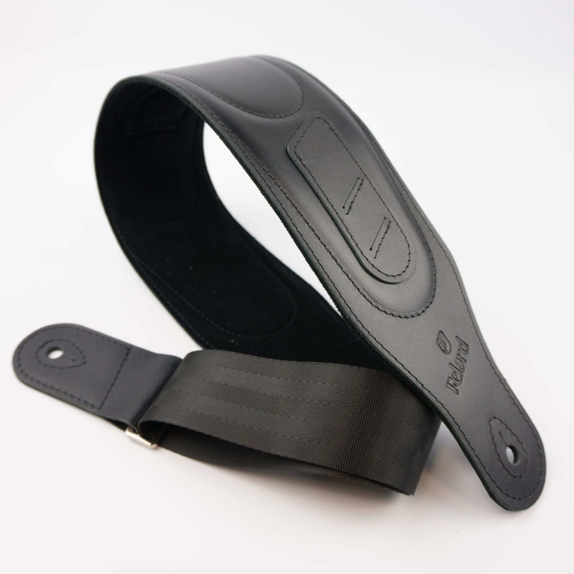A black guitar strap made of leather and webbing, shown on a clean white background. The brand name 'Felard' is embossed on the leather end.